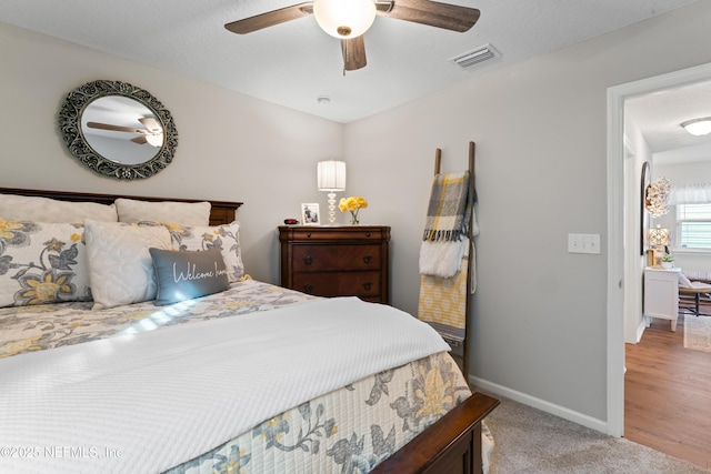 bedroom with ceiling fan and light colored carpet