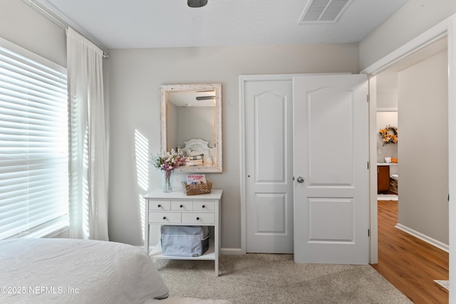 bedroom featuring light carpet