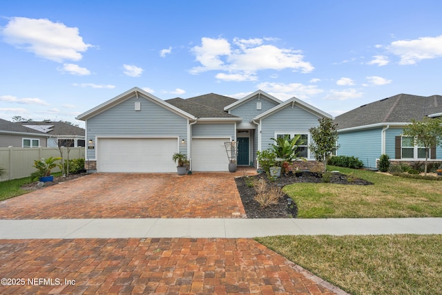 view of front of property featuring a garage and a front yard