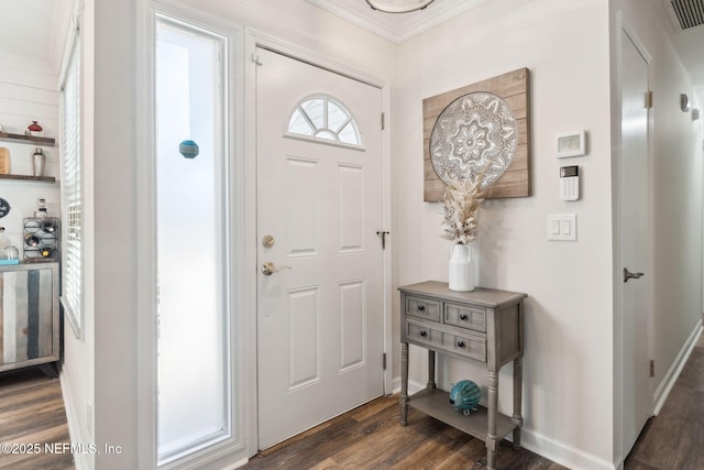 foyer entrance with dark hardwood / wood-style flooring and ornamental molding