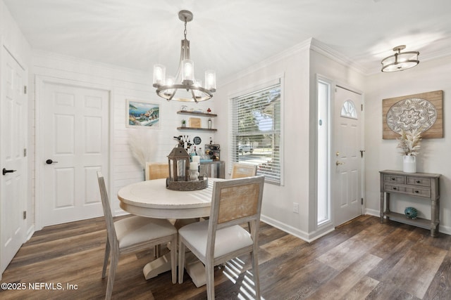 dining area with dark hardwood / wood-style floors and an inviting chandelier