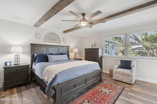 bedroom featuring beam ceiling, wood-type flooring, and ceiling fan