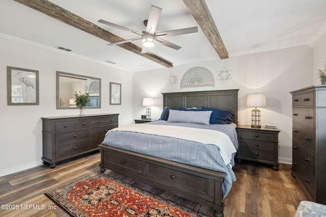 bedroom featuring ceiling fan, ornamental molding, dark hardwood / wood-style floors, and beam ceiling