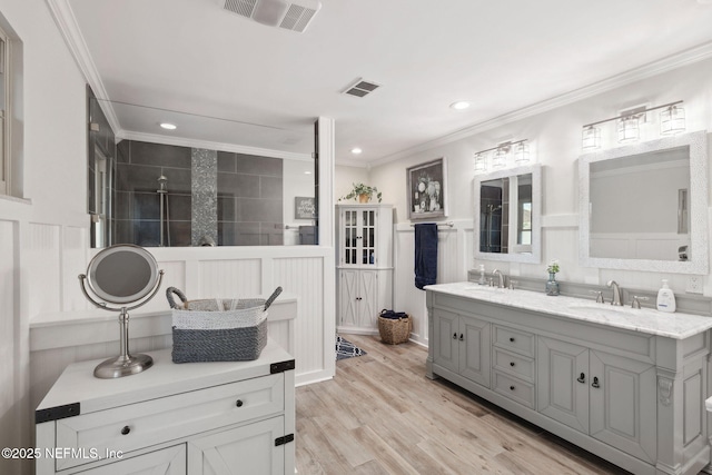 bathroom featuring vanity, hardwood / wood-style flooring, and crown molding