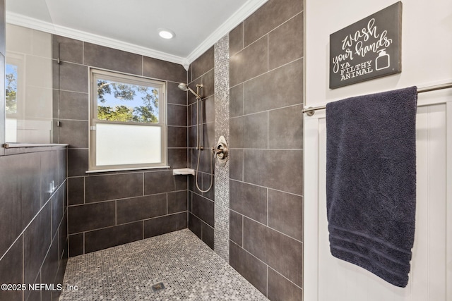 bathroom featuring a tile shower and crown molding