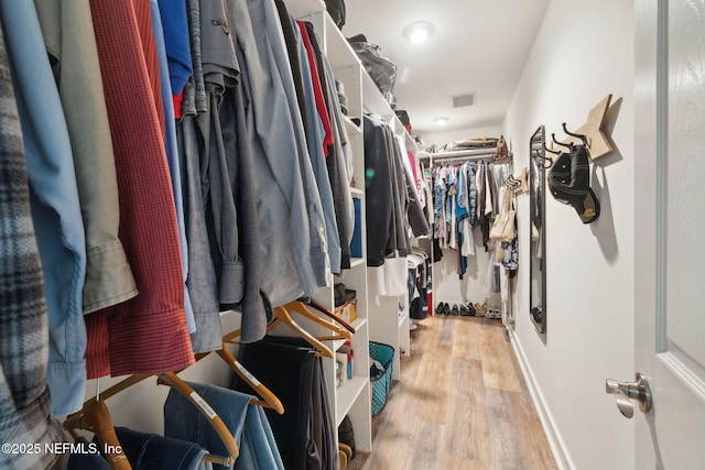 walk in closet featuring light hardwood / wood-style floors