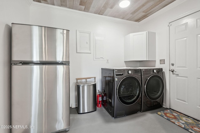 laundry room with crown molding, cabinets, wood ceiling, and washer and clothes dryer