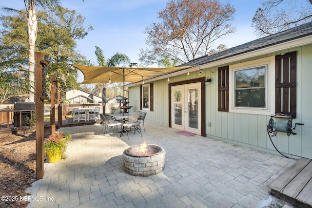 view of patio / terrace with french doors and a fire pit