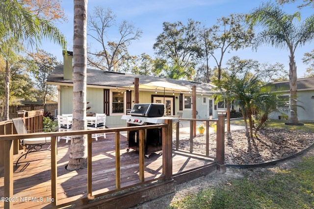 rear view of property featuring a deck