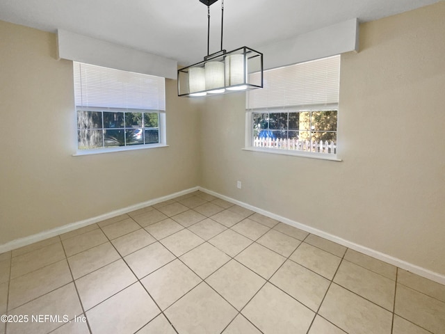 unfurnished dining area featuring light tile patterned floors