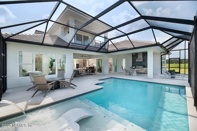 view of pool featuring ceiling fan, a patio, and glass enclosure