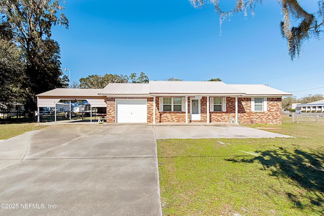 ranch-style home featuring a garage, a front lawn, and a carport