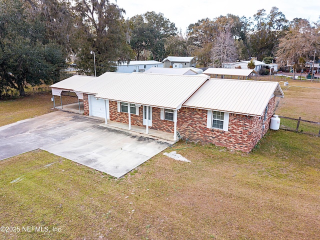 view of front of home featuring a garage, a front yard, and a carport