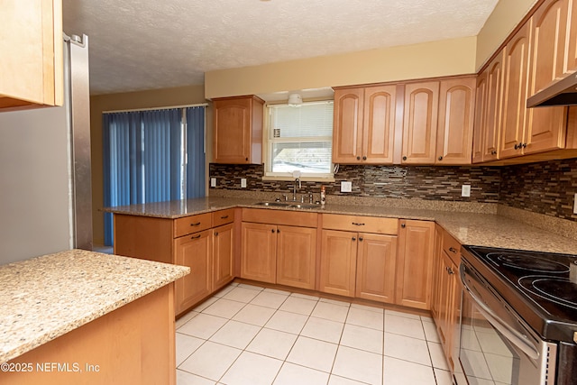 kitchen with backsplash, stainless steel electric range, sink, light stone countertops, and light tile patterned floors