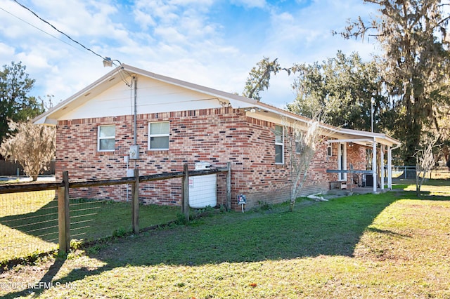 view of side of property with a lawn