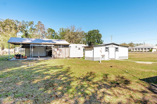 view of yard with a carport and an outdoor structure