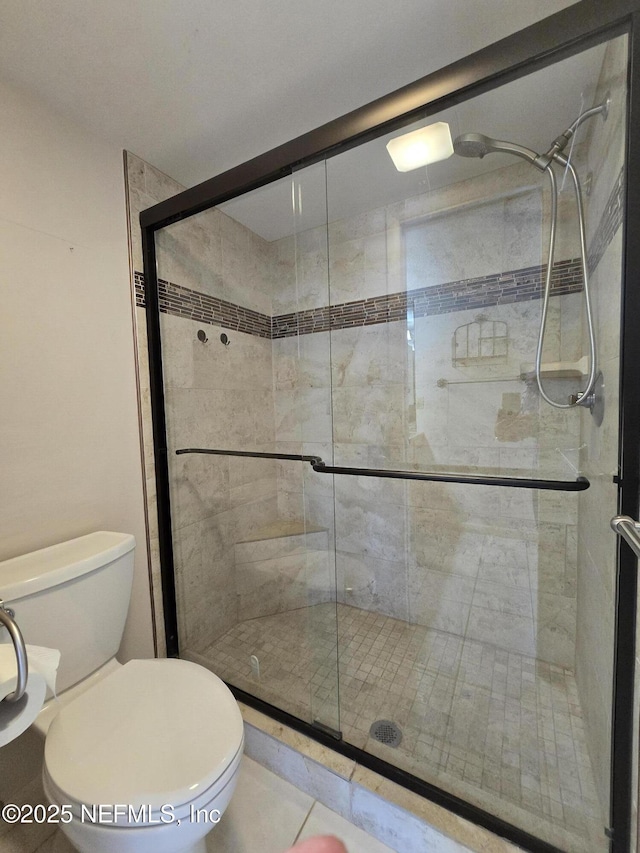 bathroom with an enclosed shower and toilet