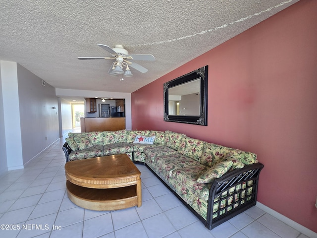 tiled living room featuring ceiling fan and a textured ceiling