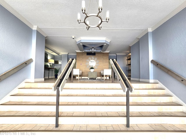 stairway featuring ornamental molding, a chandelier, and a textured ceiling