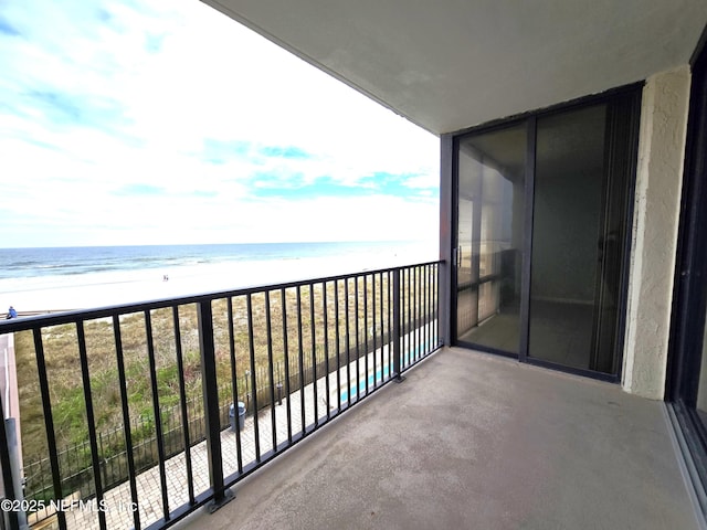 balcony with a view of the beach and a water view