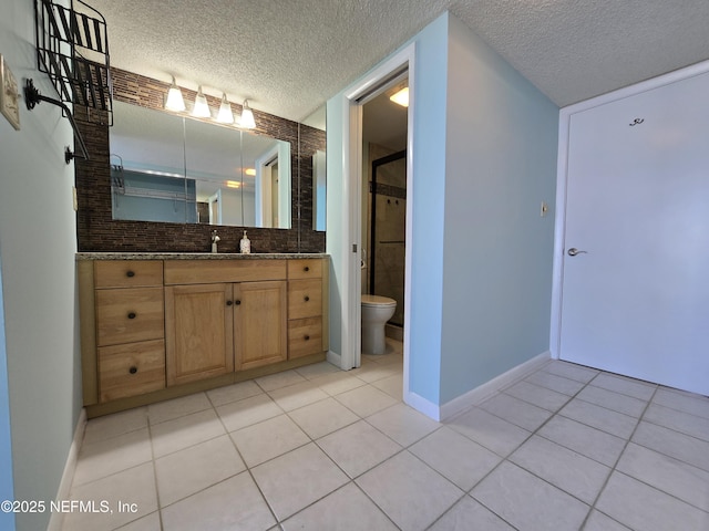 bathroom featuring toilet, a textured ceiling, a shower stall, vanity, and tile patterned flooring