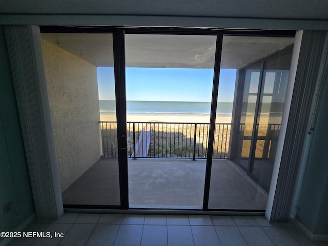 balcony featuring a water view and a beach view