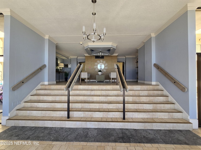 stairs with a textured ceiling, ornamental molding, and a notable chandelier