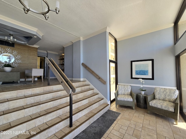 stairs featuring stone finish flooring, ornamental molding, and a textured ceiling