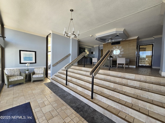 interior space with a textured ceiling, ornamental molding, and a notable chandelier