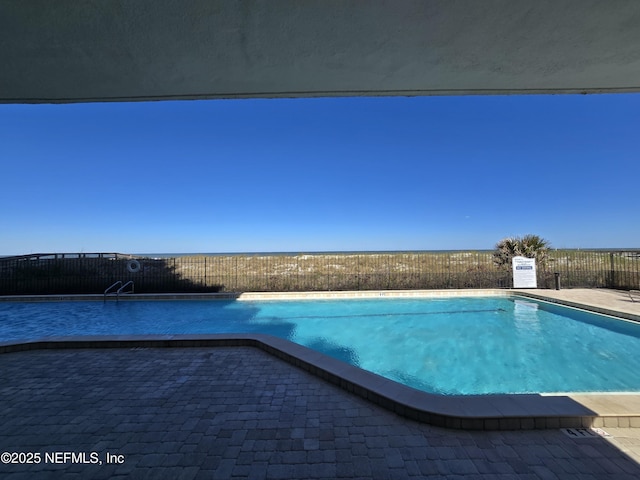 pool featuring a patio area and fence