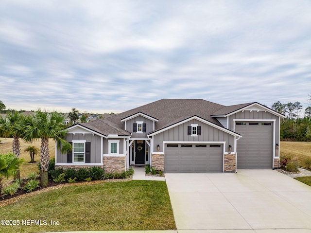 view of front of property with a garage and a front lawn