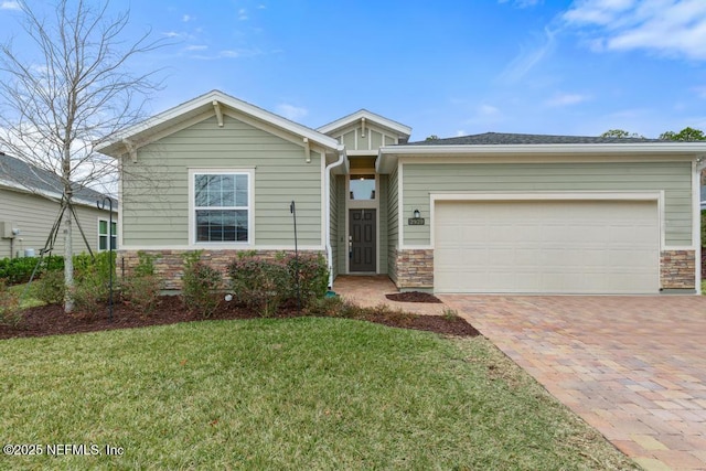 view of front of property with a garage and a front lawn