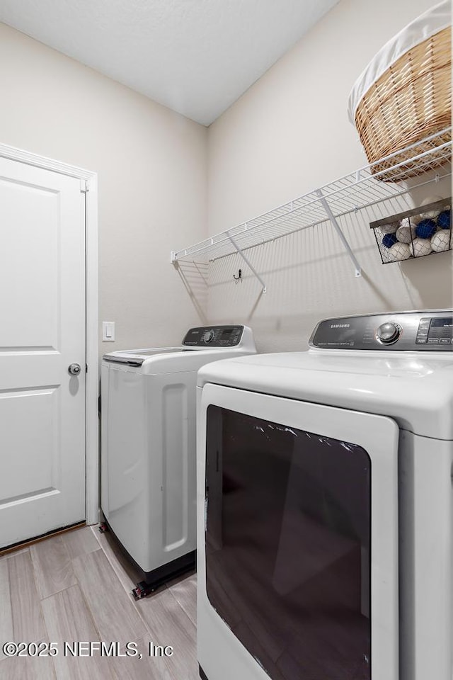 laundry area with separate washer and dryer