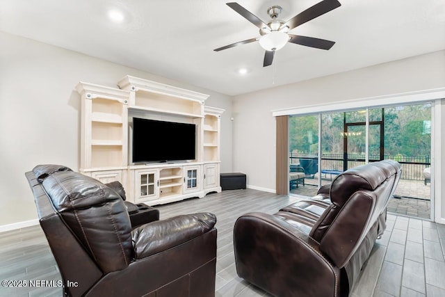 living room with light wood-type flooring and ceiling fan