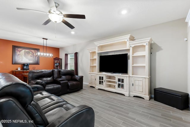 living room featuring ceiling fan and light hardwood / wood-style floors