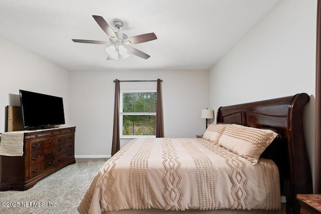 bedroom with ceiling fan and light colored carpet