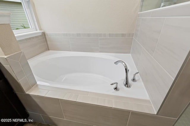 bathroom with a relaxing tiled tub