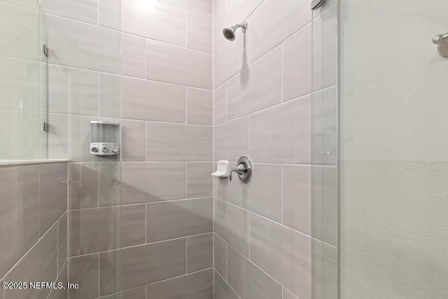 bathroom with tiled shower