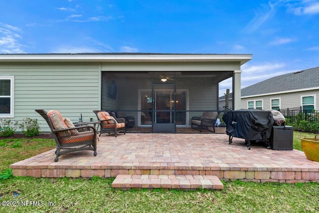 back of property with a patio area and a sunroom