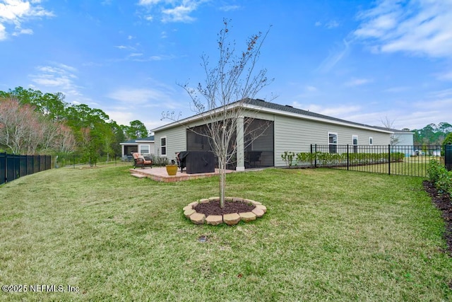 back of house featuring a patio area, a sunroom, and a yard