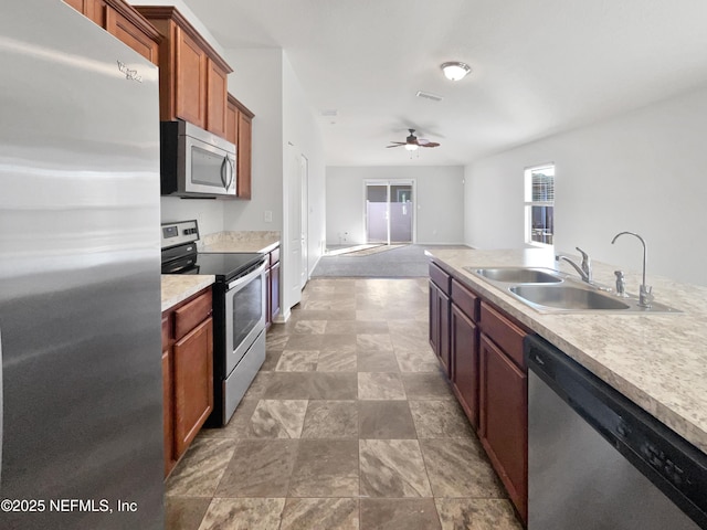 kitchen featuring sink, ceiling fan, and stainless steel appliances