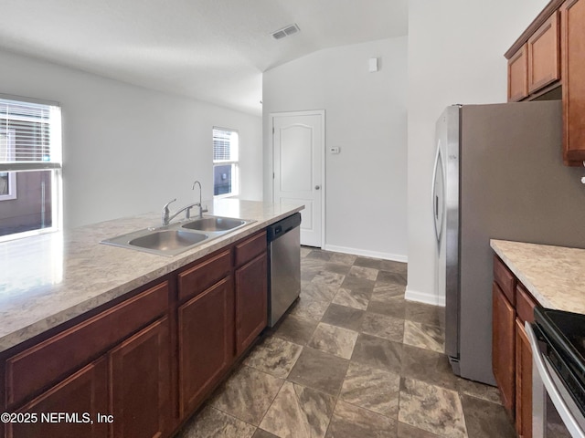 kitchen with sink, lofted ceiling, and stainless steel appliances