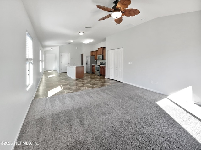 unfurnished living room featuring ceiling fan and lofted ceiling