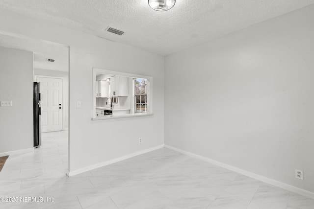 empty room with a textured ceiling