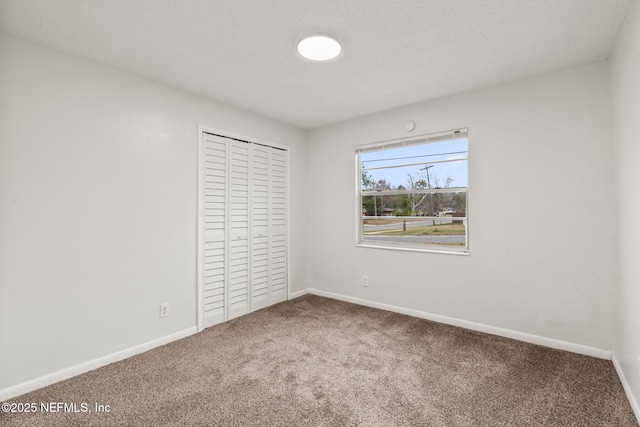 unfurnished bedroom with carpet flooring and a closet