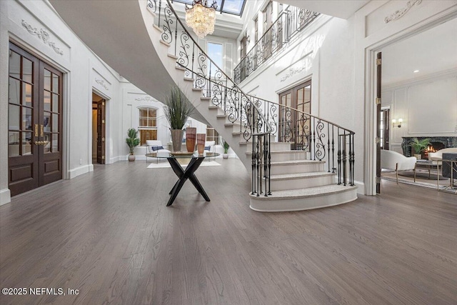 entryway featuring a high ceiling, wood-type flooring, and french doors