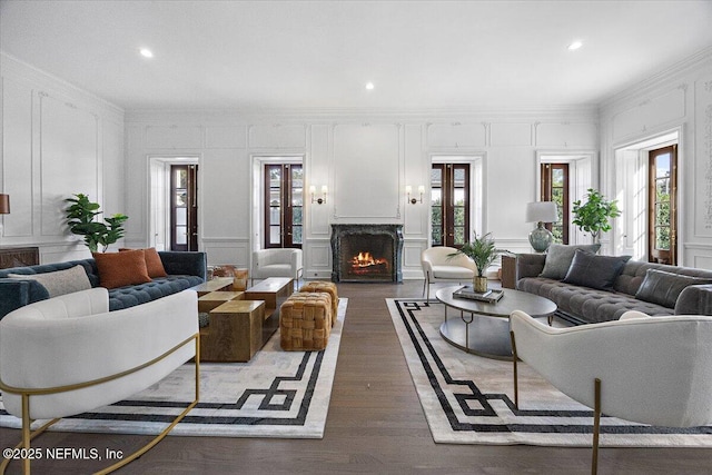 living room with dark wood-type flooring, crown molding, and french doors