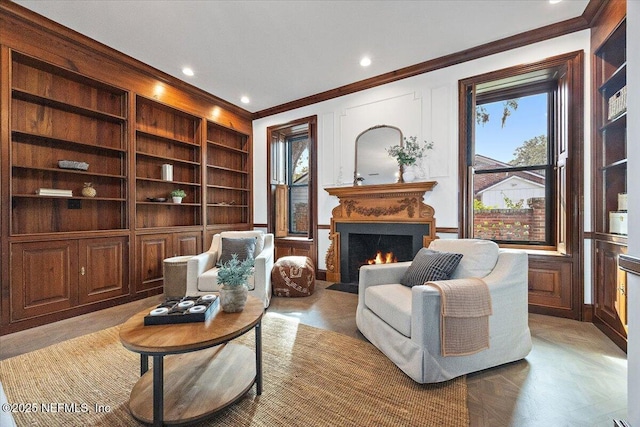 sitting room featuring ornamental molding and built in features