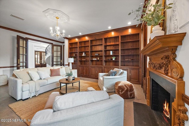 living room with french doors, built in features, crown molding, and a notable chandelier