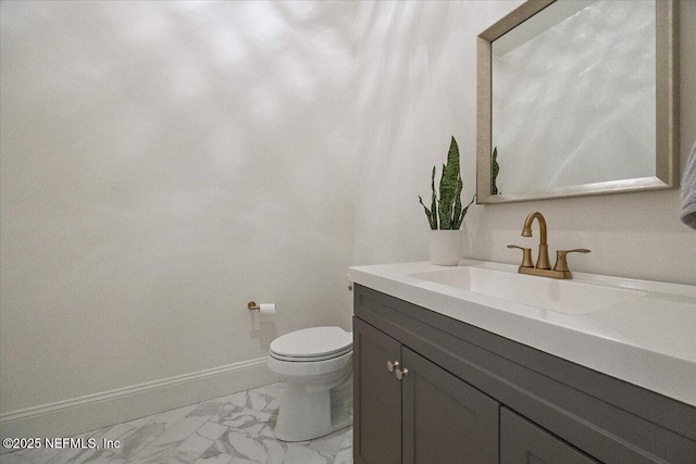 bathroom featuring toilet and vanity